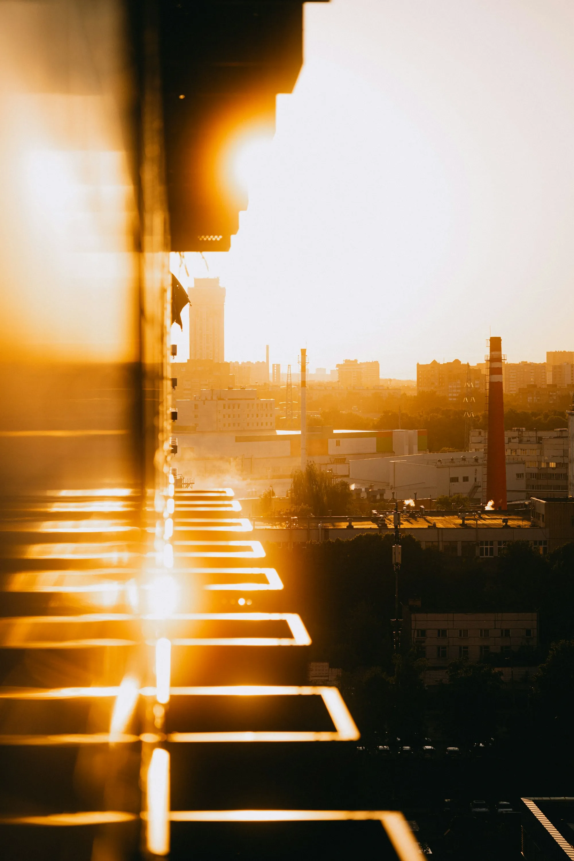 Bright summer sun glaring over a city skyline